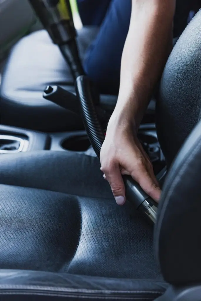 cropped view of car cleaner vacuuming drivers seat 2024 11 18 03 31 09 utc